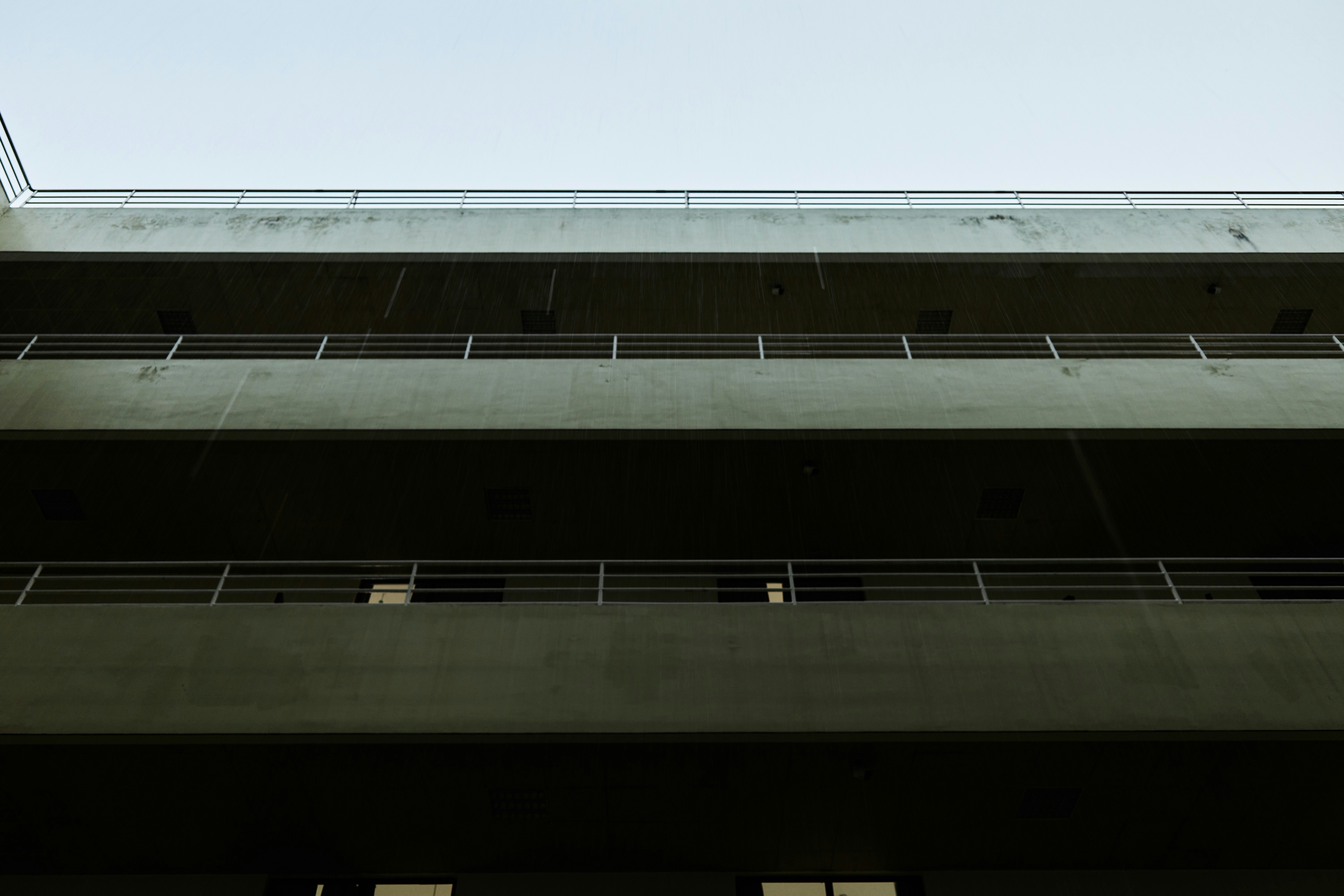 a tall building with balconies and a sky background