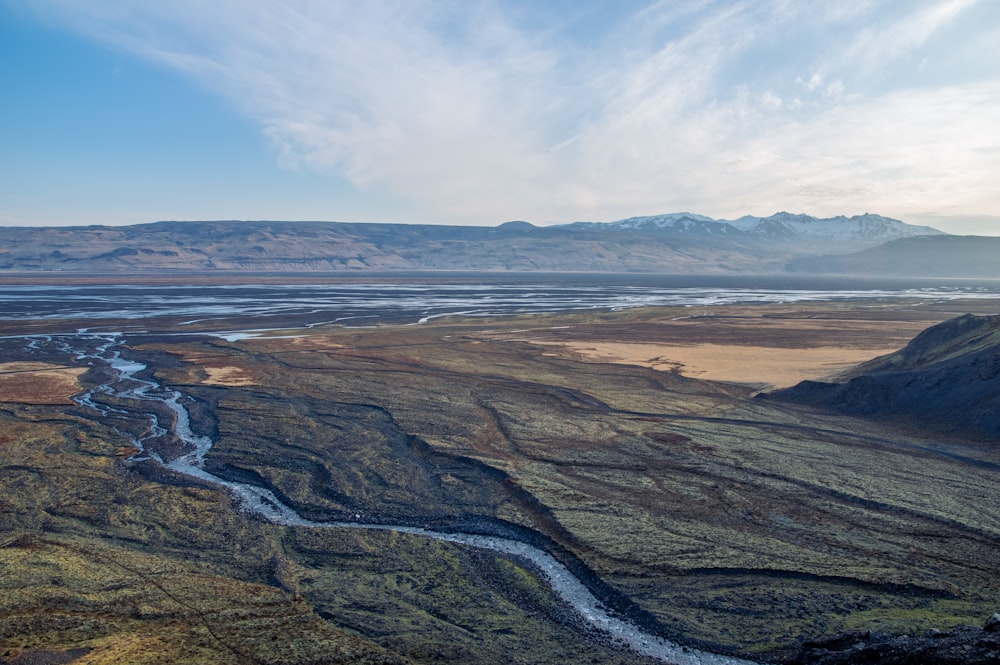 a river running through a valley surrounded by mountains