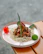 Close-up of a beautifully plated traditional Saudi dish with rich colors and textures.