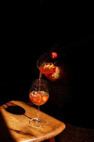 a glass of wine being poured into a wine glass