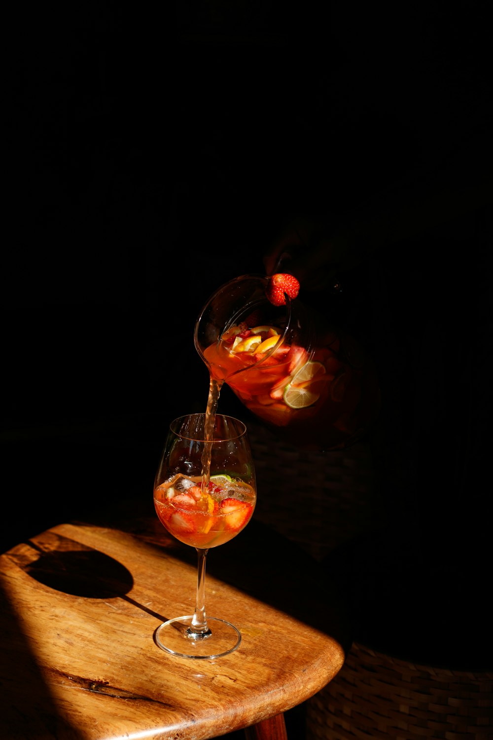 a glass of wine being poured into a wine glass