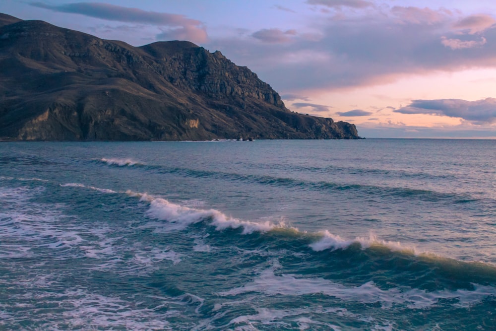 a body of water with a mountain in the background