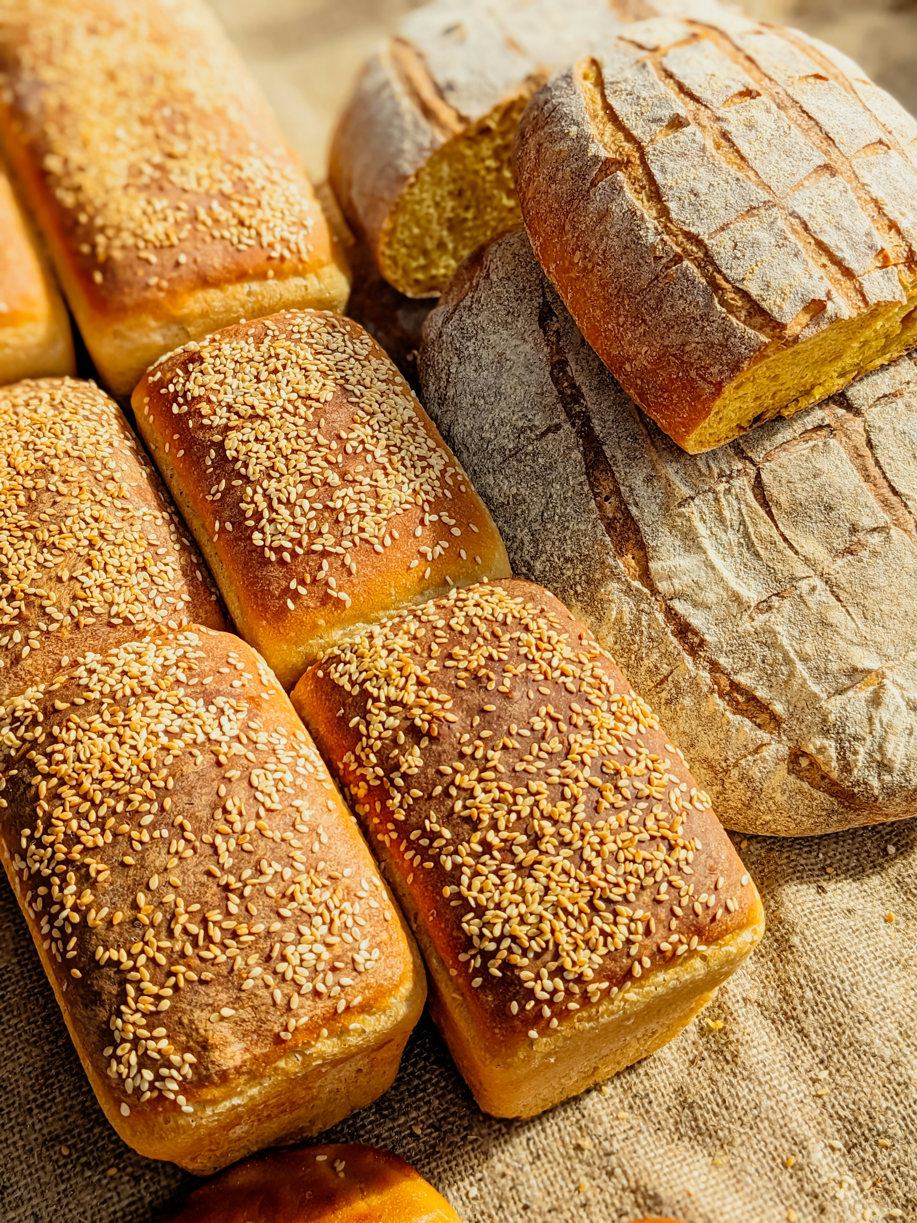 a table topped with lots of different types of bread