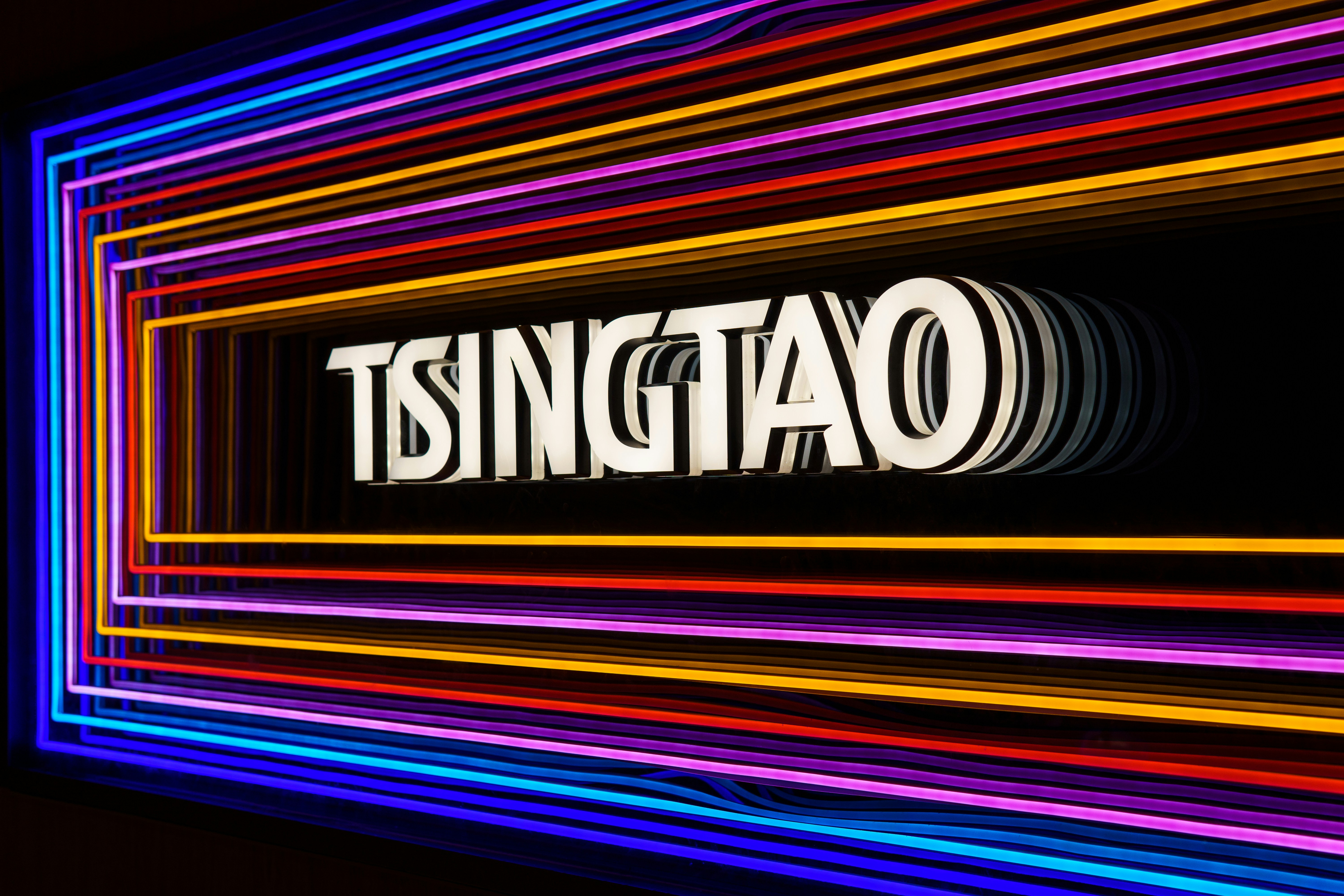 a neon sign that says tsingtato on it