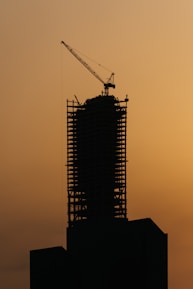 a tall building with a crane on top of it