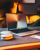 A stylish laptop on a desk surrounded by trendy accessories.