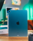 a blue ipad sitting on top of a wooden table