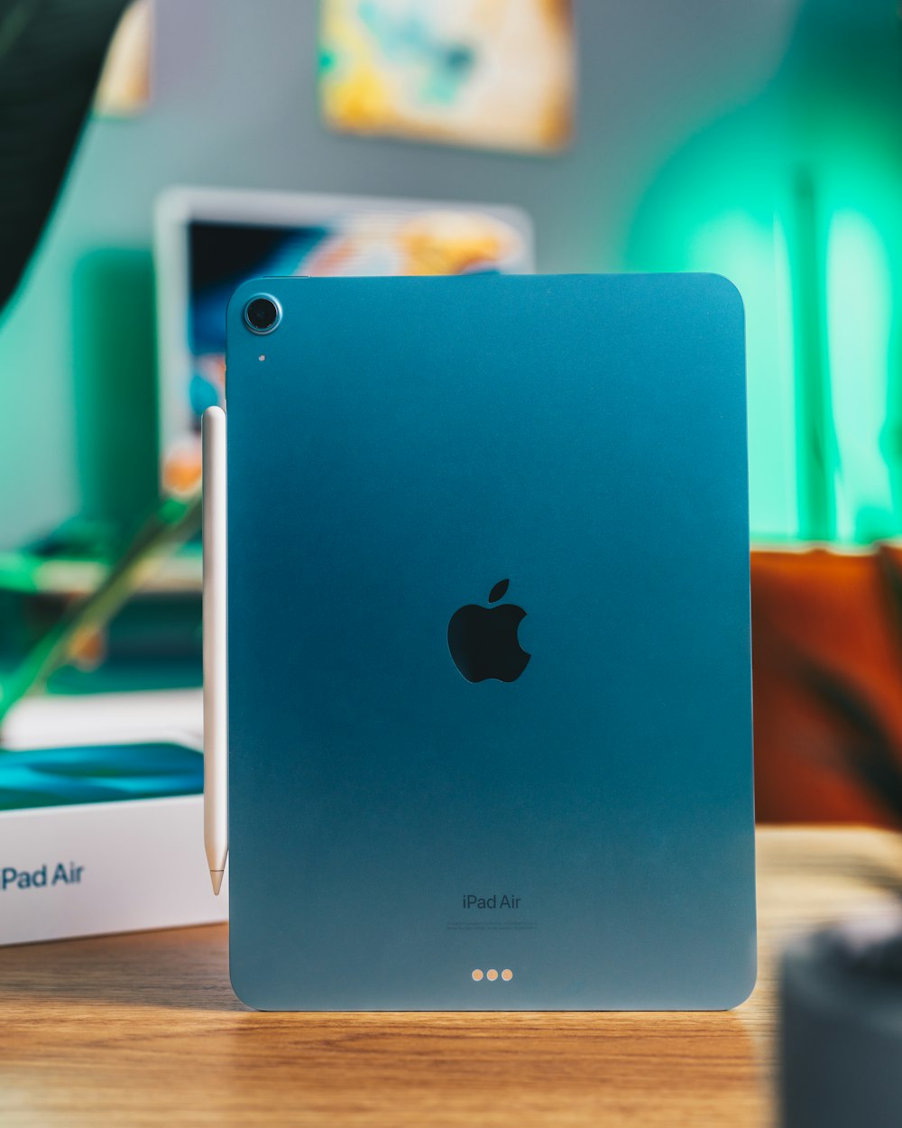 a blue ipad sitting on top of a wooden table