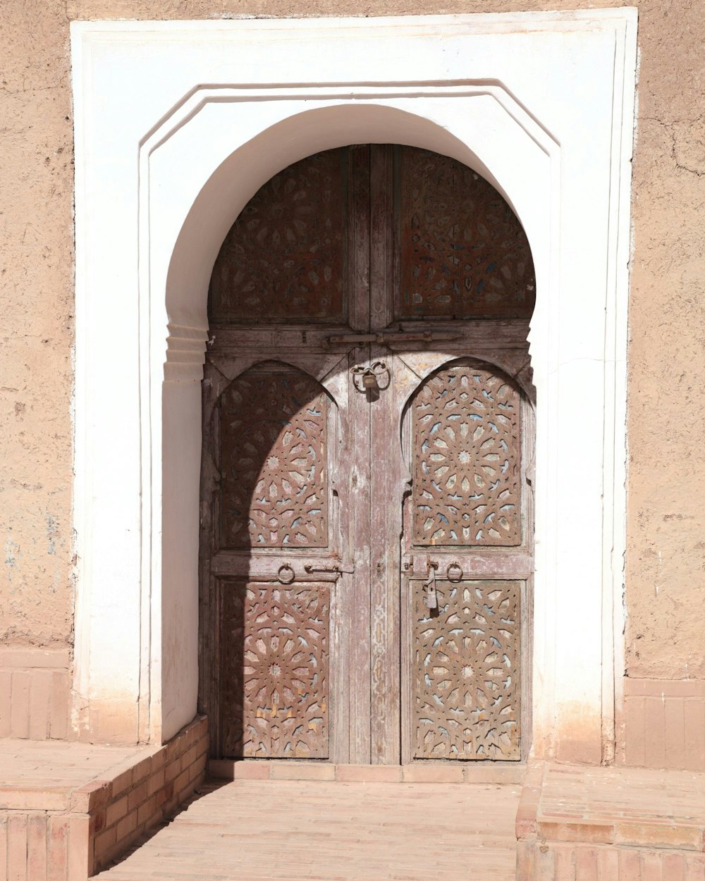 a large wooden door sitting inside of a building