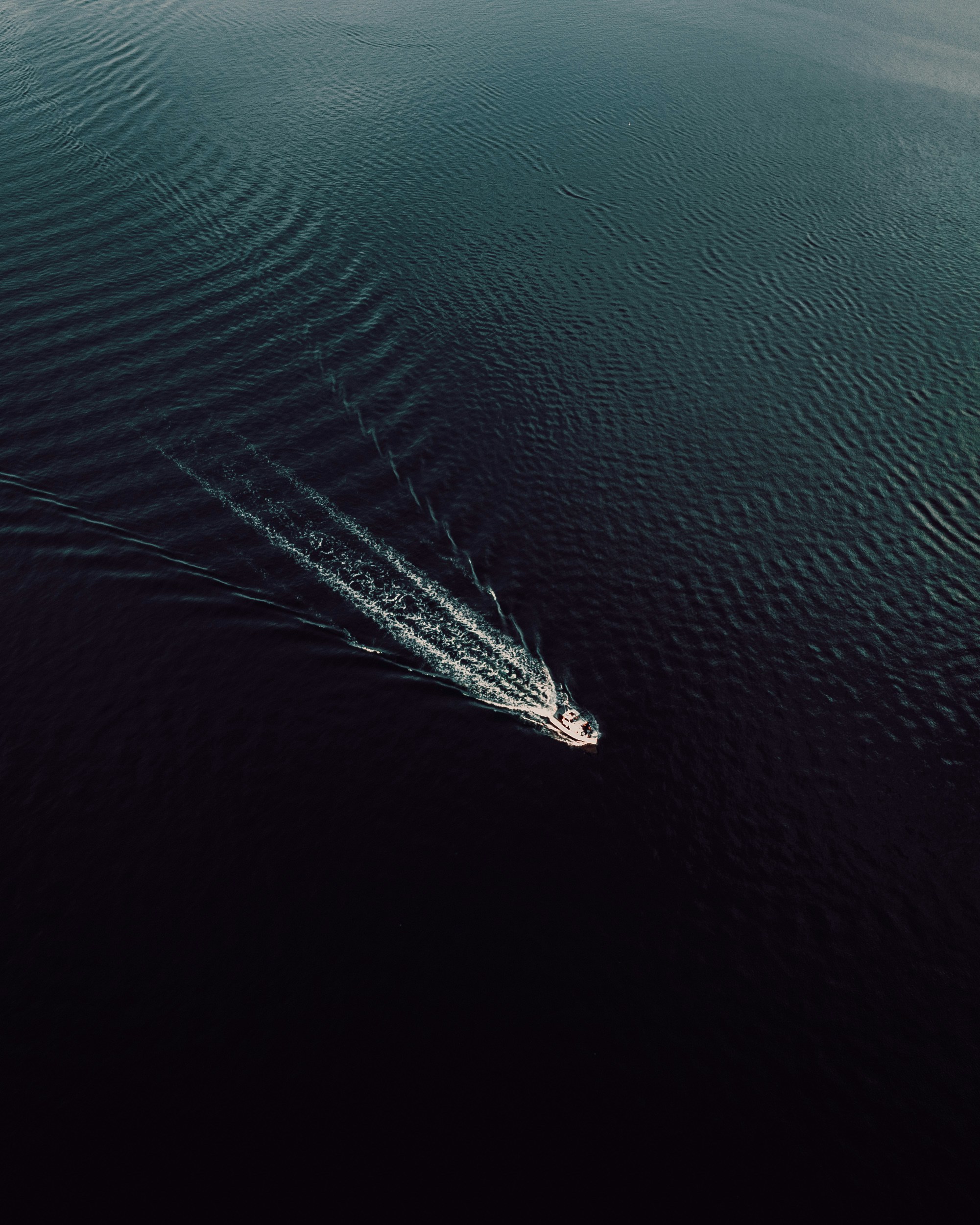 an aerial view of a boat in the water