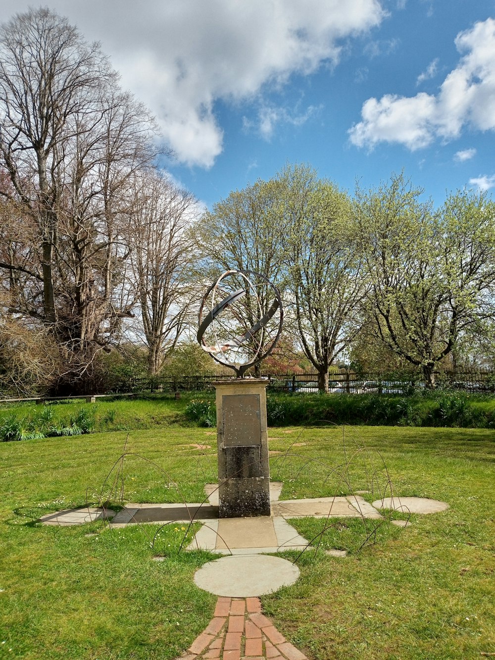 a statue in the middle of a grassy field