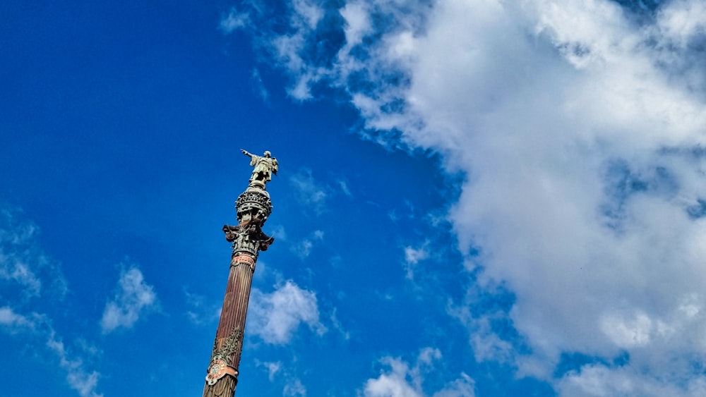 a tall pole with a statue on top of it