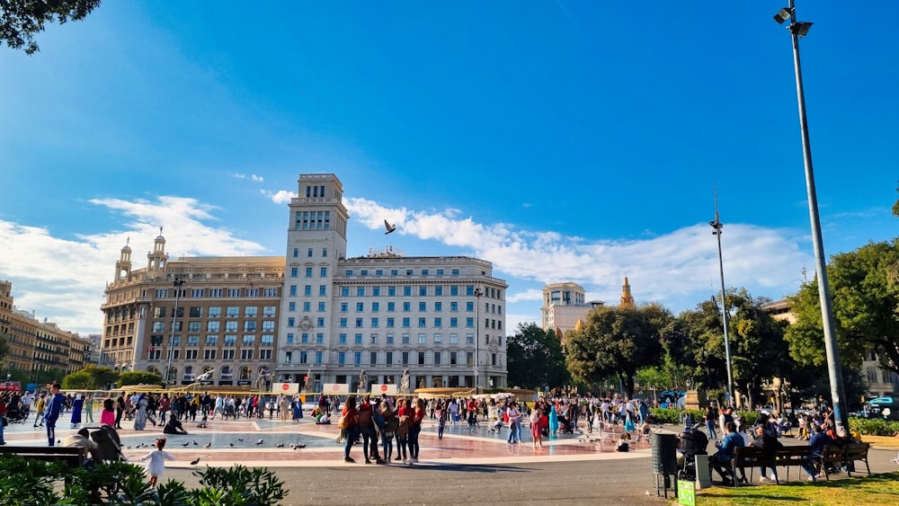 a crowd of people walking around a city square