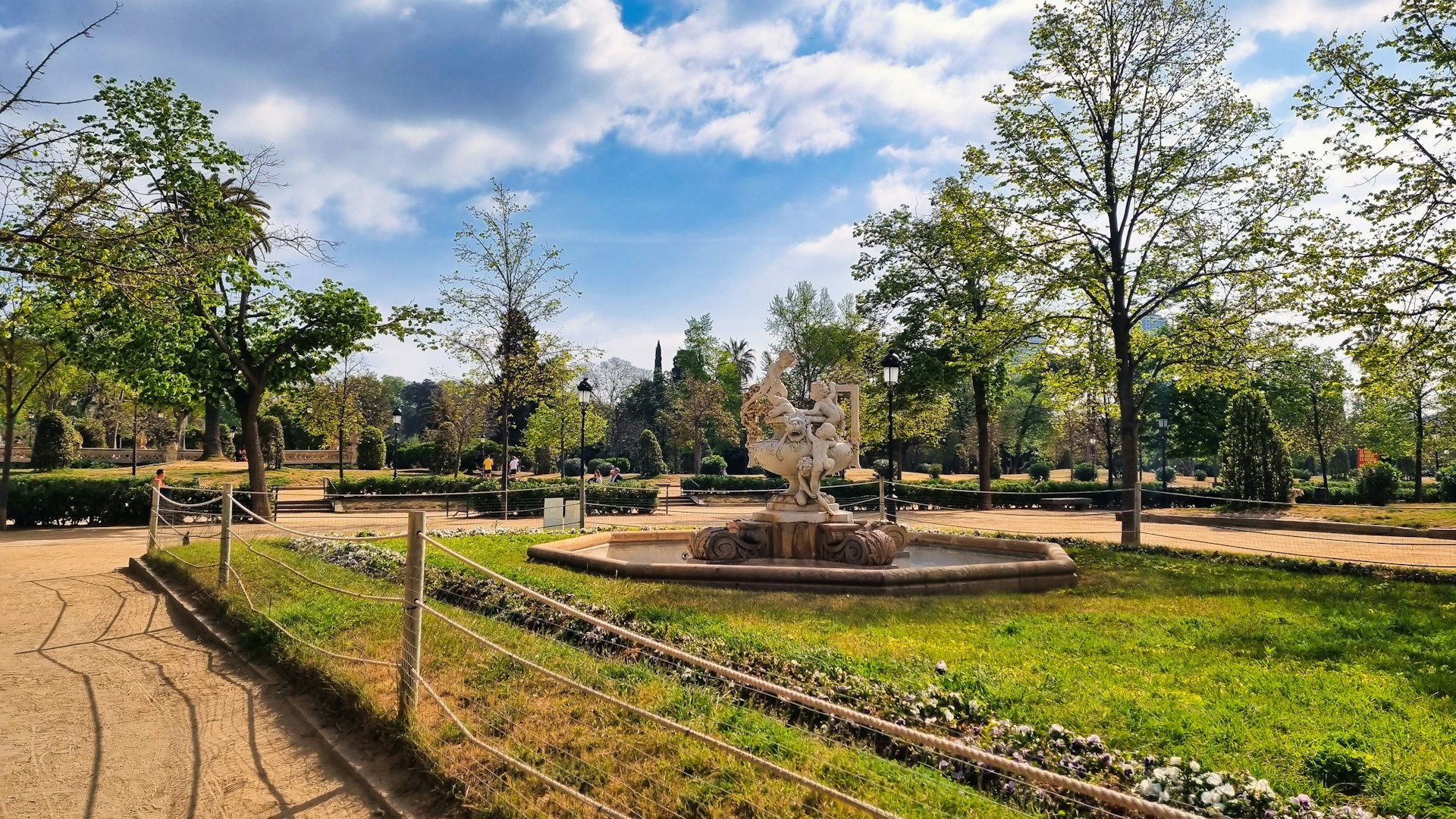 a park with a fountain surrounded by trees