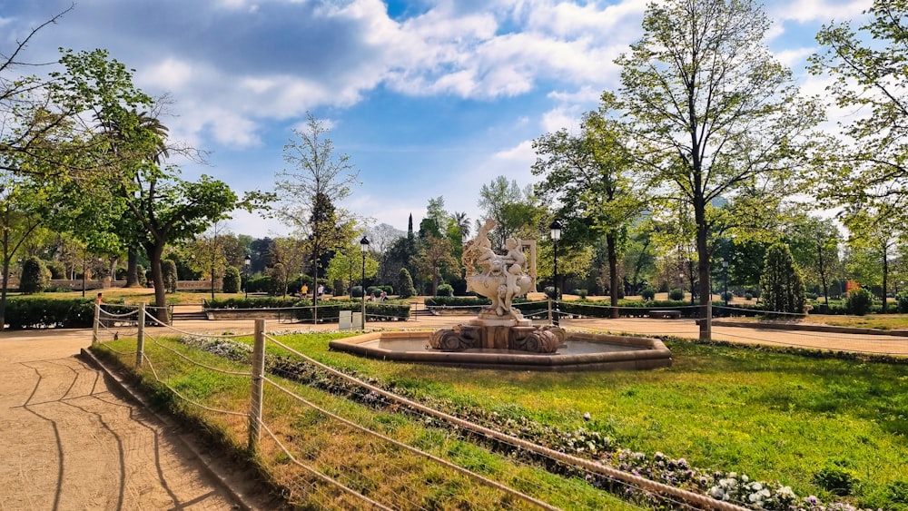 a park with a fountain surrounded by trees