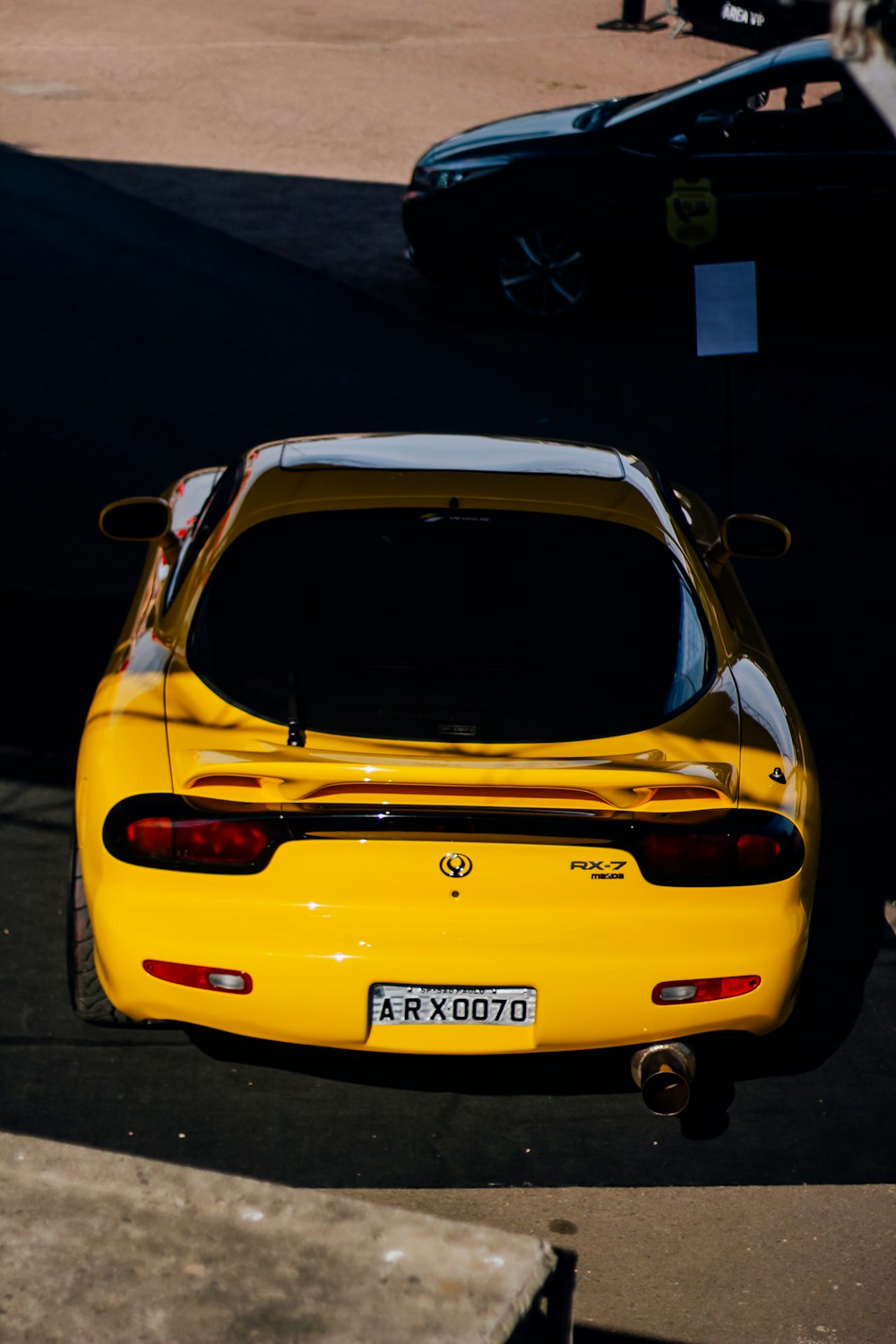 a yellow sports car parked in a parking lot