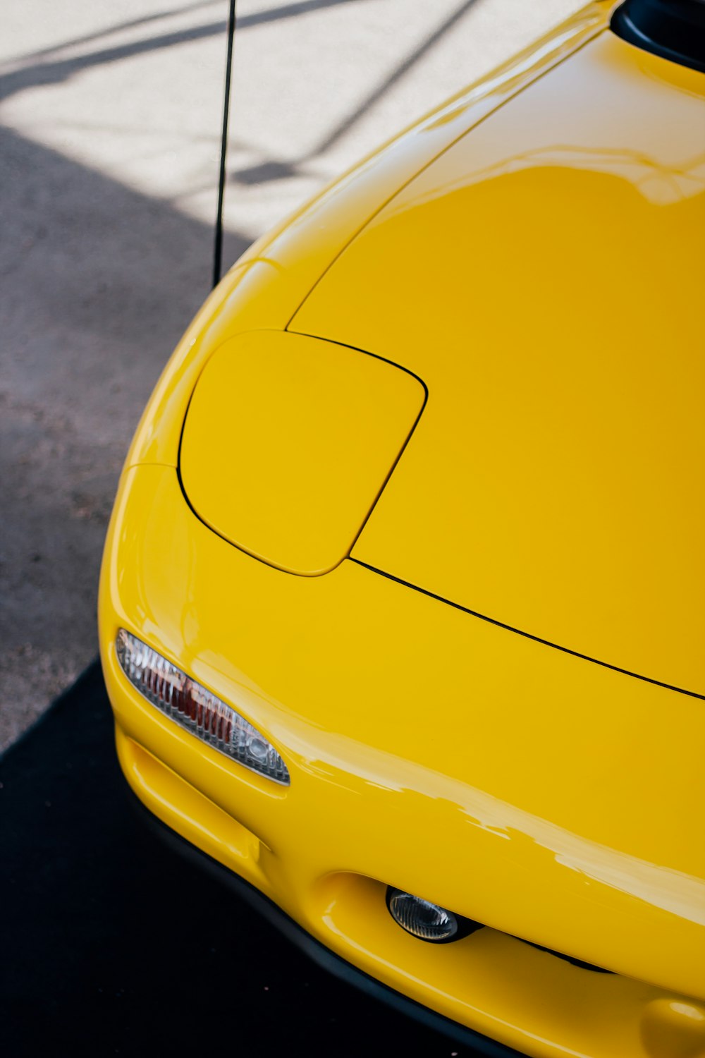 the front end of a yellow sports car