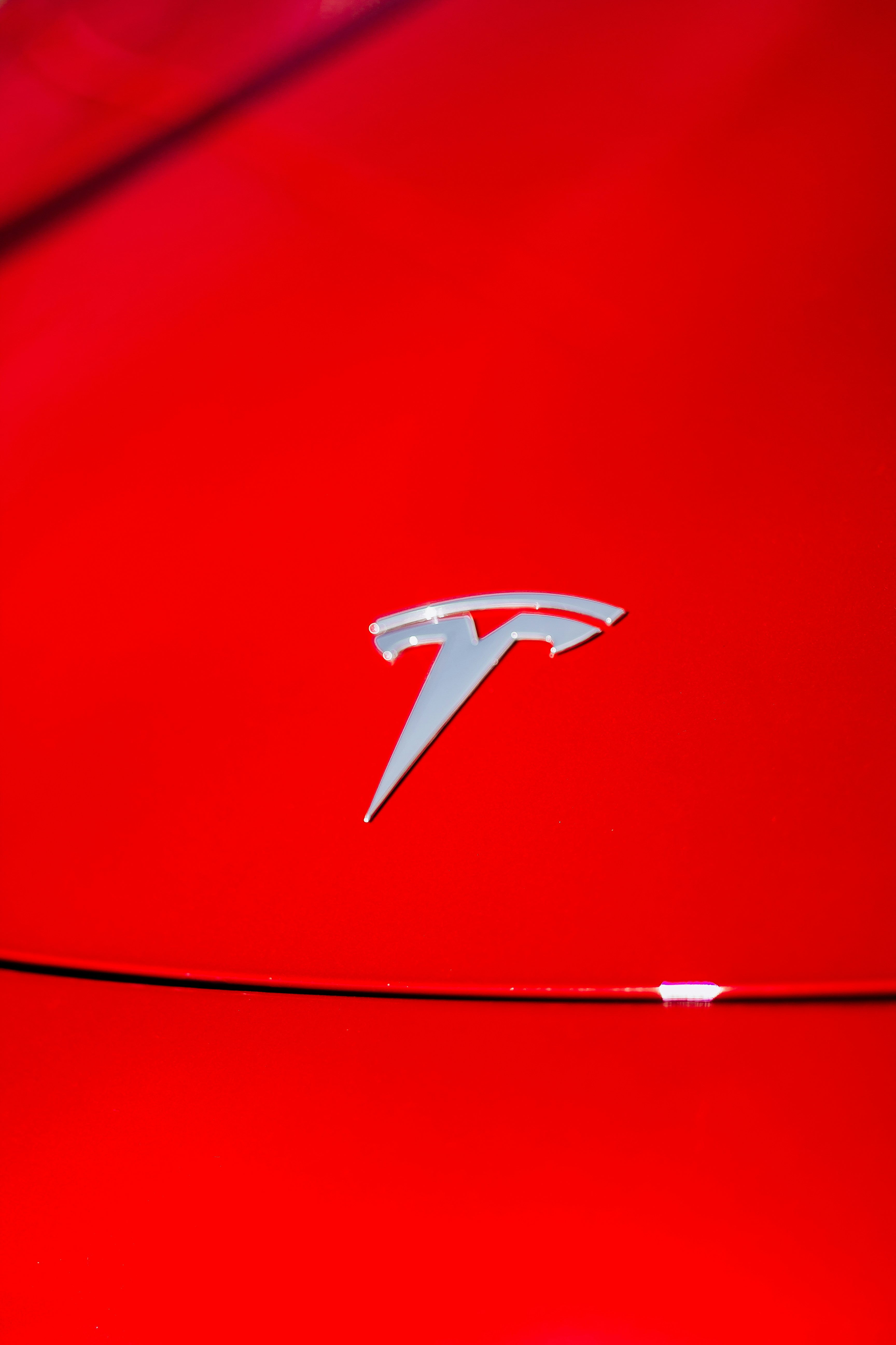 a close up of the emblem on a red sports car