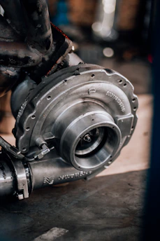 Close-up of a turbocharger being installed on a Volkswagen engine with precision tools.