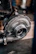 Technician carefully inspecting a turbocharger in a clean workshop.