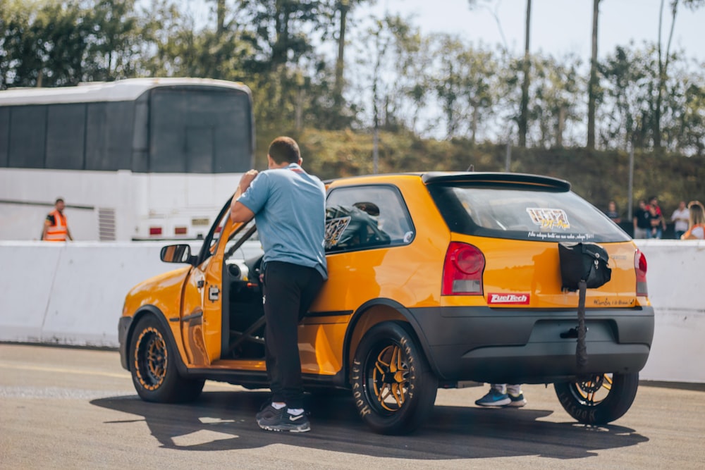 a man standing in the back of a yellow truck