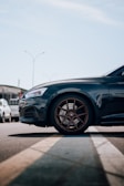 A stylish car parked with a focus on its wheels.
