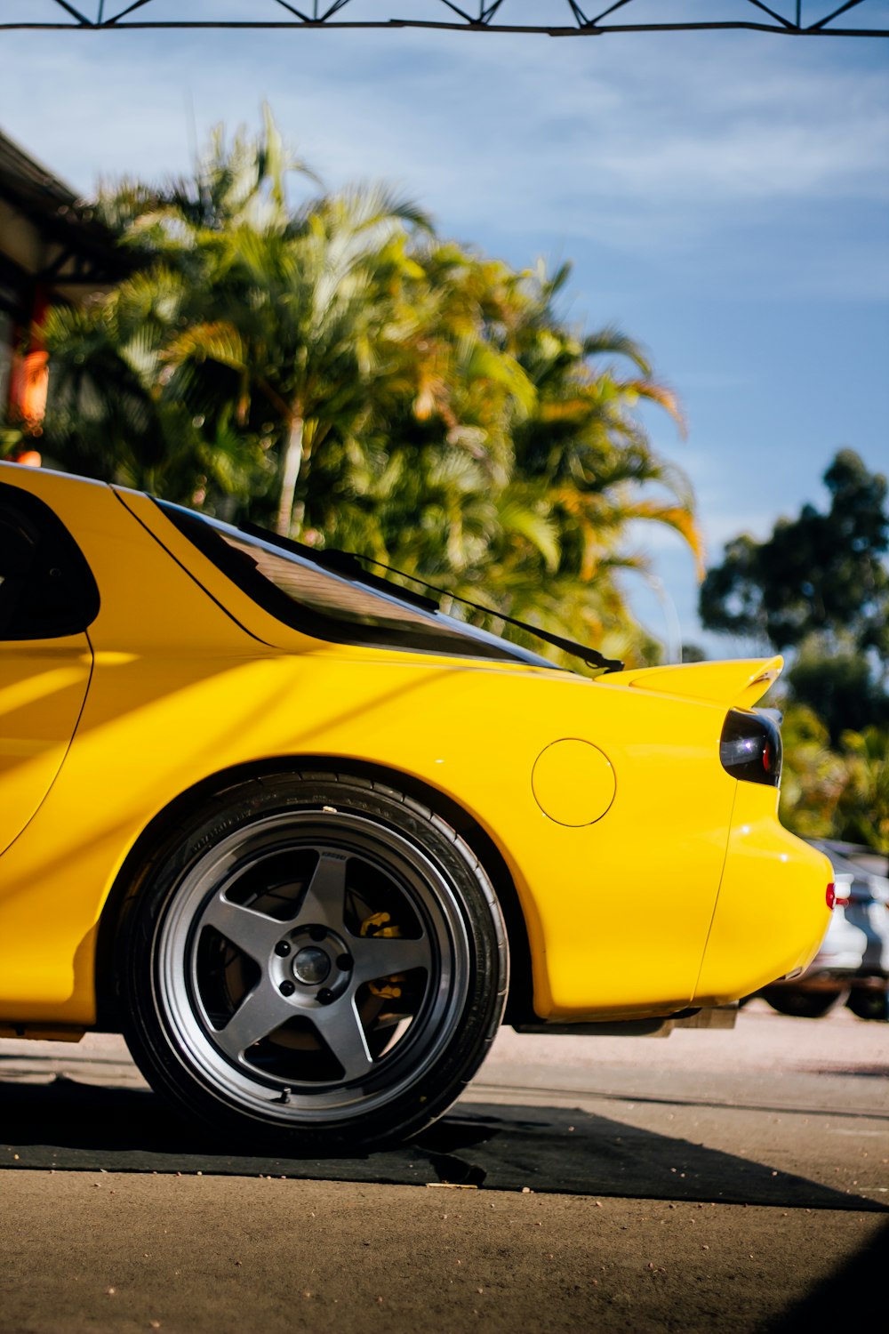 a yellow sports car parked on the side of the road