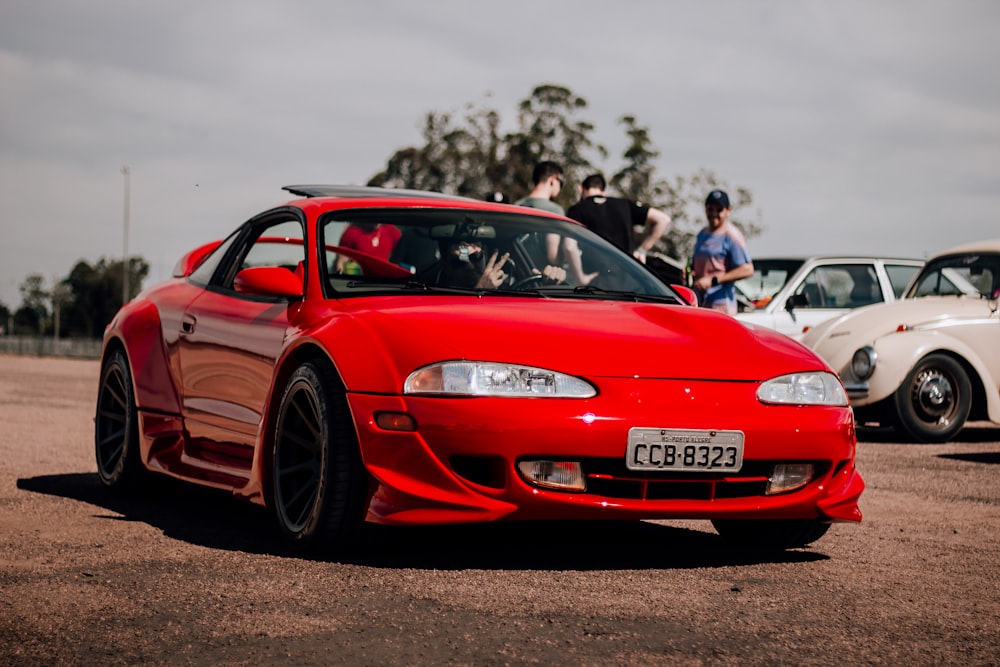 a red sports car parked in a parking lot