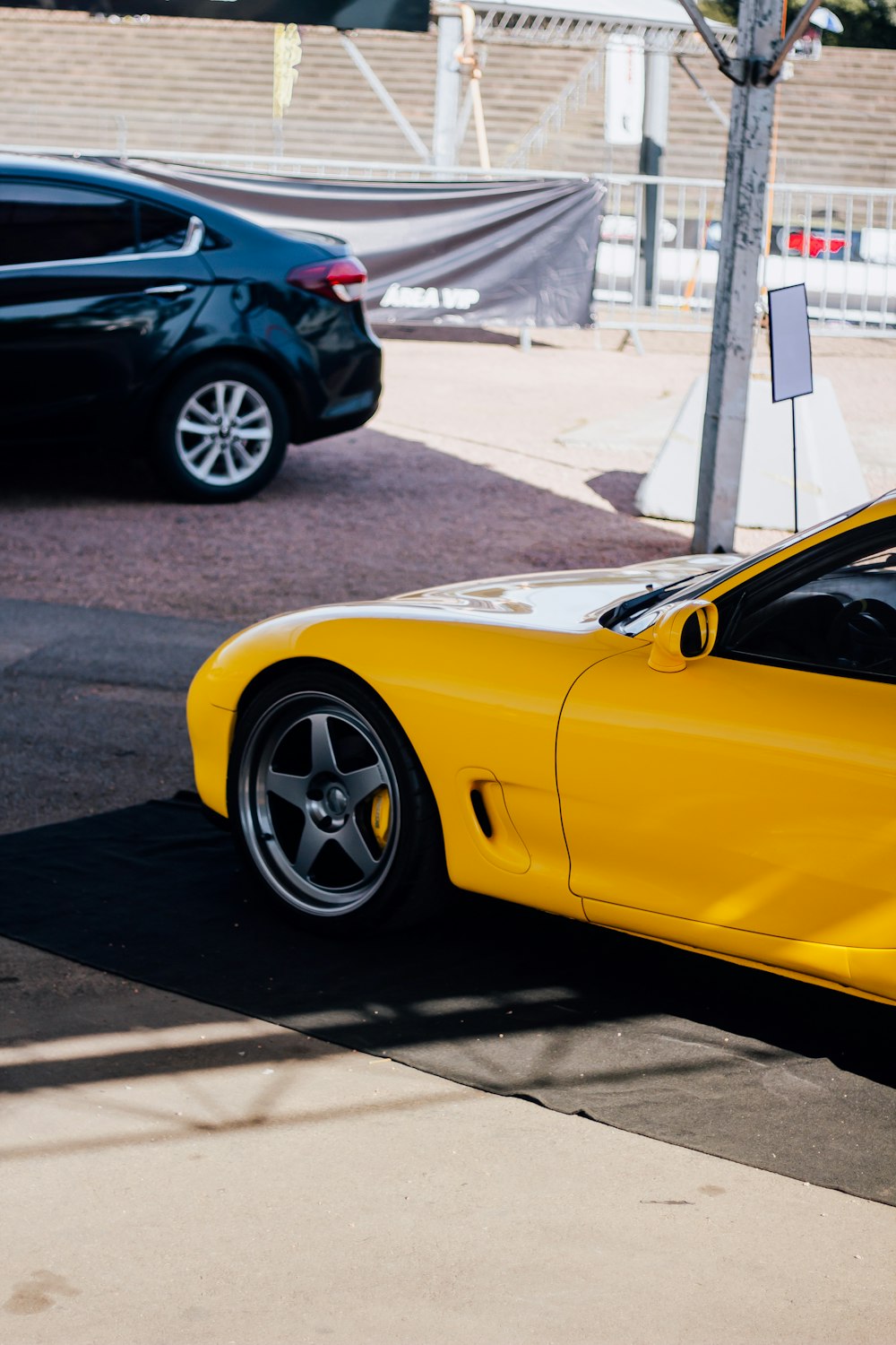 a yellow sports car parked on the side of the road