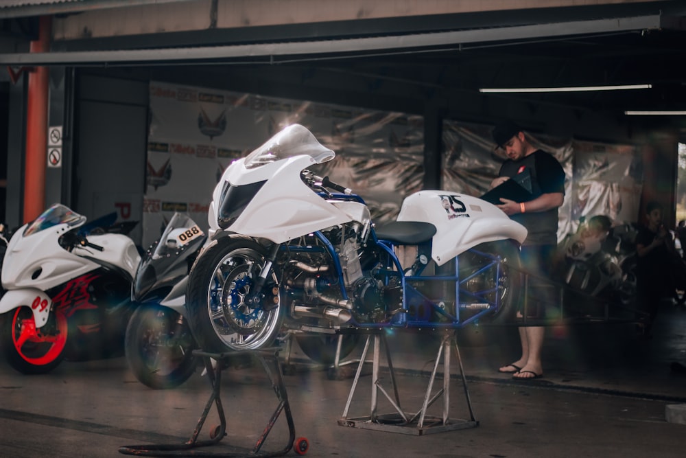 two motorcycles parked next to each other in a garage