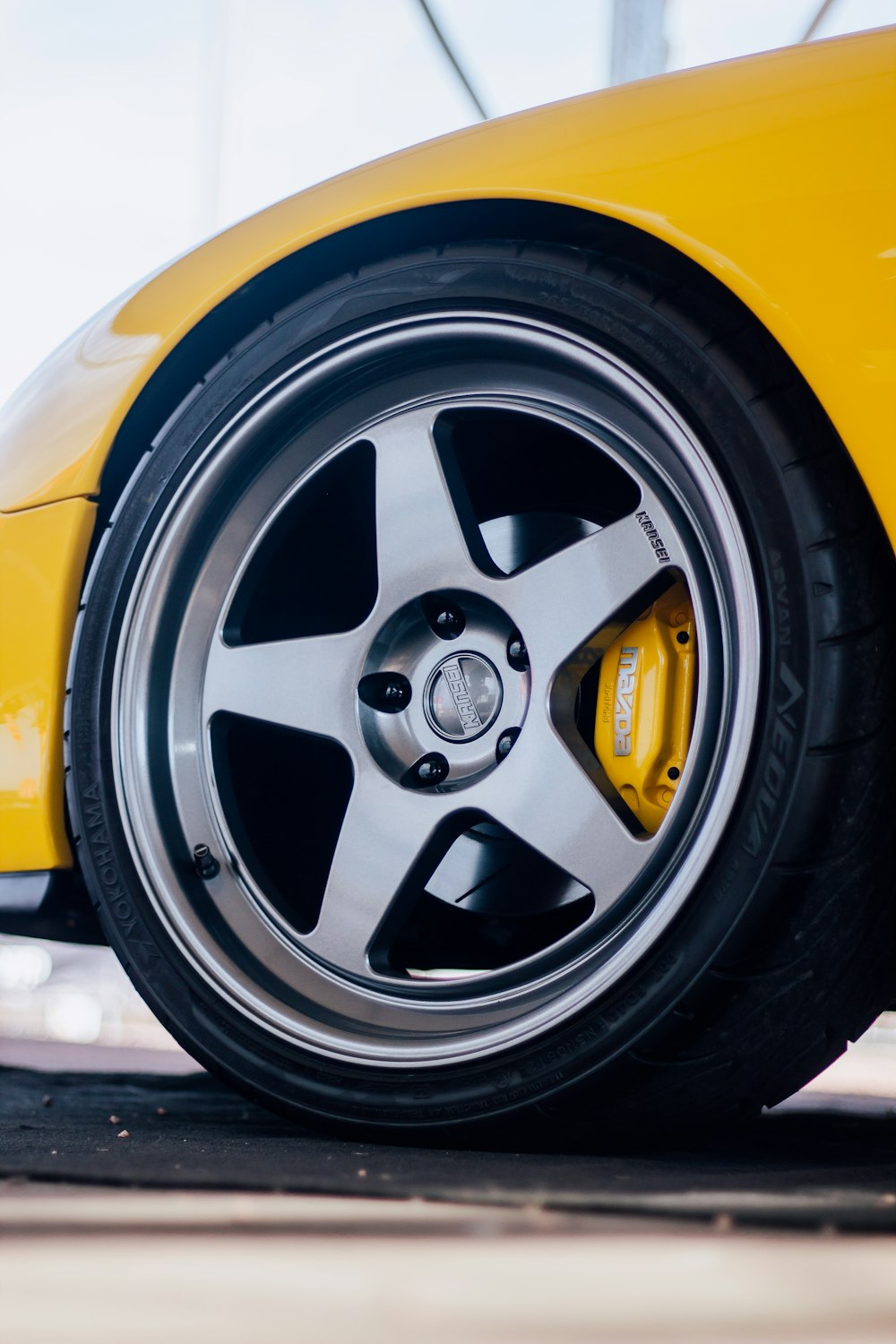 a close up of a yellow sports car tire