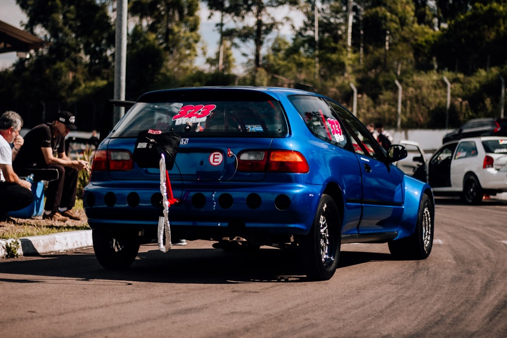 a blue car parked on the side of a road