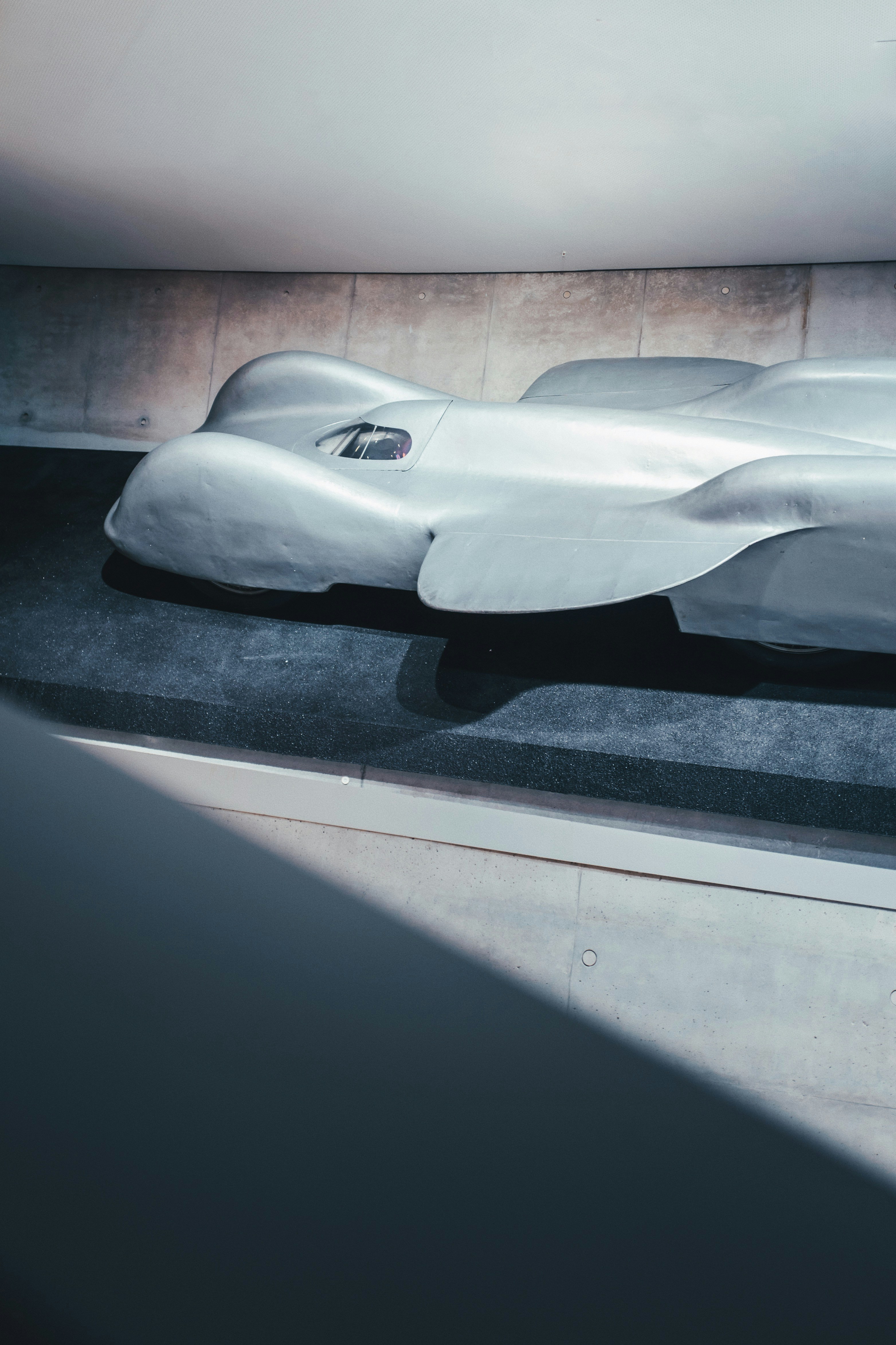 a futuristic car is on display in a museum