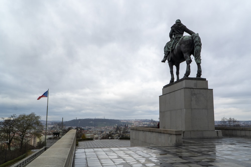 a statue of a man on a horse on a cloudy day