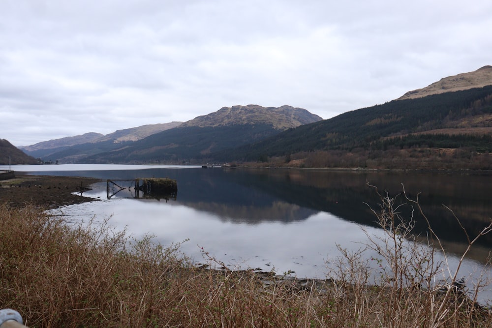 a body of water with mountains in the background