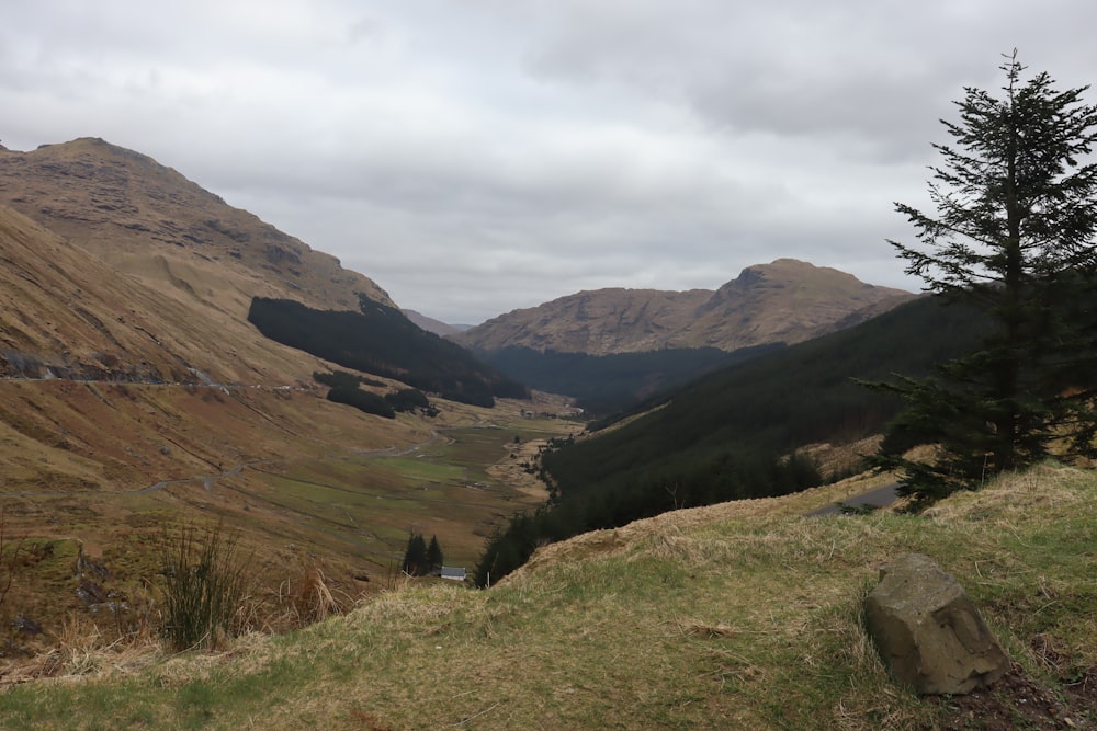 a view of a valley with mountains in the background