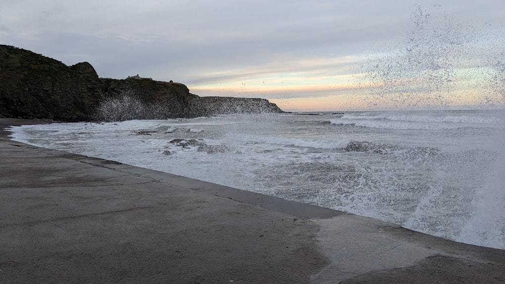 a large body of water next to a cliff