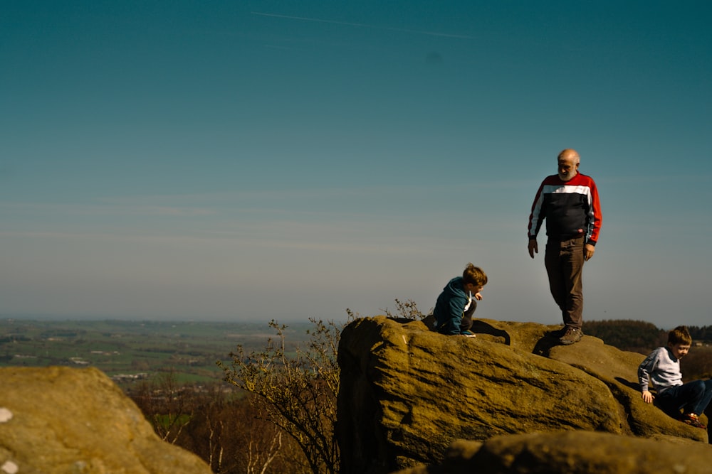 a man standing on top of a large rock