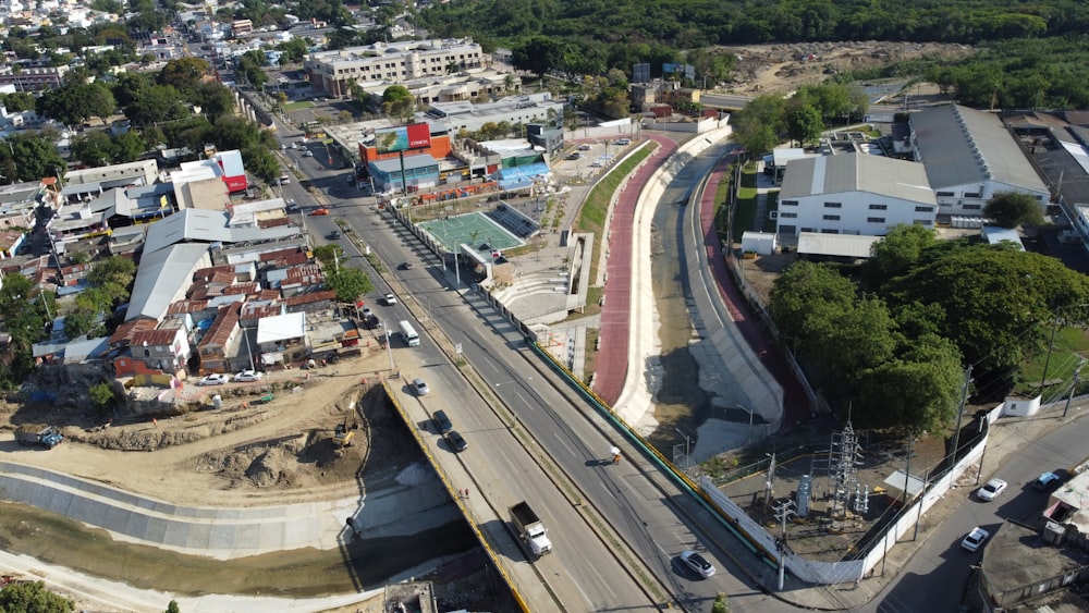 an aerial view of a city with a train track