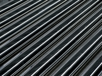 Close-up of a sleek black powder coated metal frame with a smooth matte finish