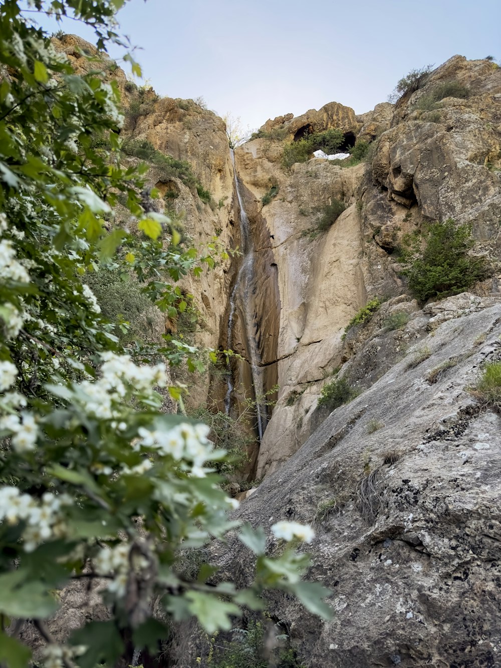 a waterfall in the middle of a rocky cliff