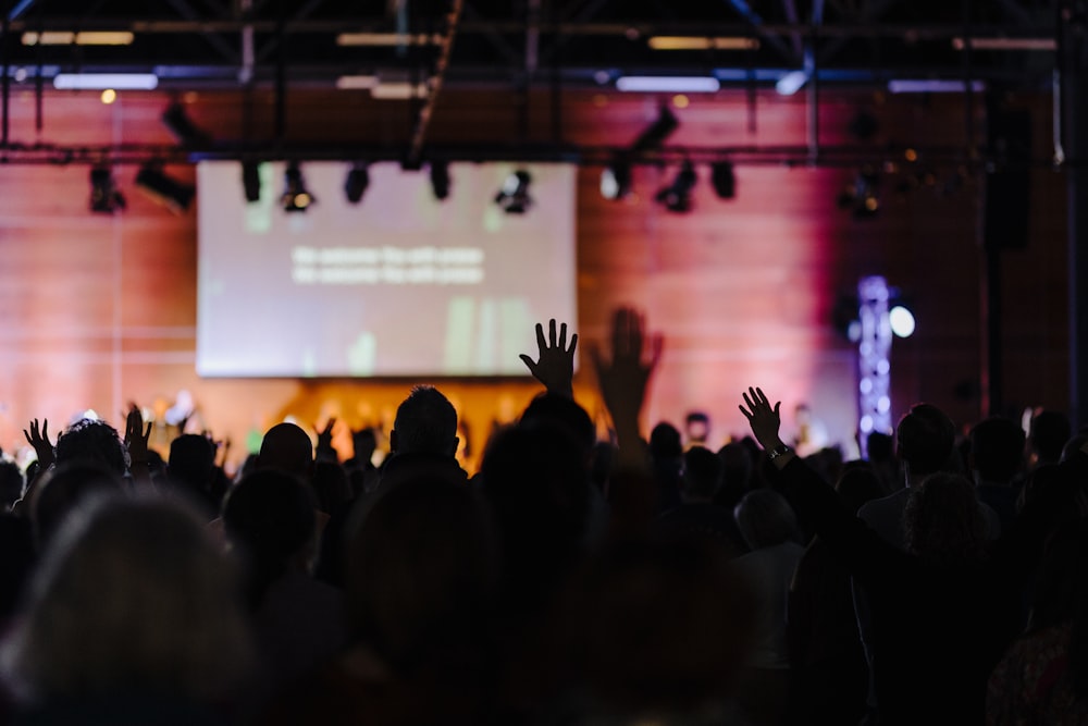 a crowd of people standing on top of a stage