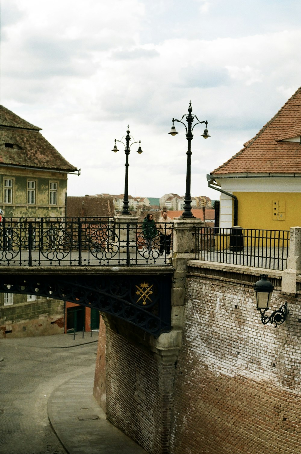 a bridge over a river with a building in the background