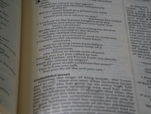 A close-up view of an open book displaying text written in a poetic format across two pages. The left page focuses on verse-style text with religious language, possibly from a scripture. The right page has more formal prose, with headings such as 'Unfaithful Israel'. The pages are cream-colored with dark text and a faint blue tint.