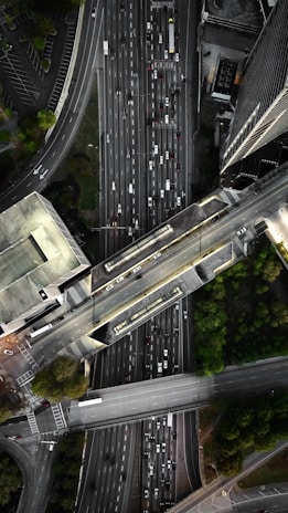 A panoramic shot of a complex interchange with multiple bridges and flyovers weaving through a cityscape.