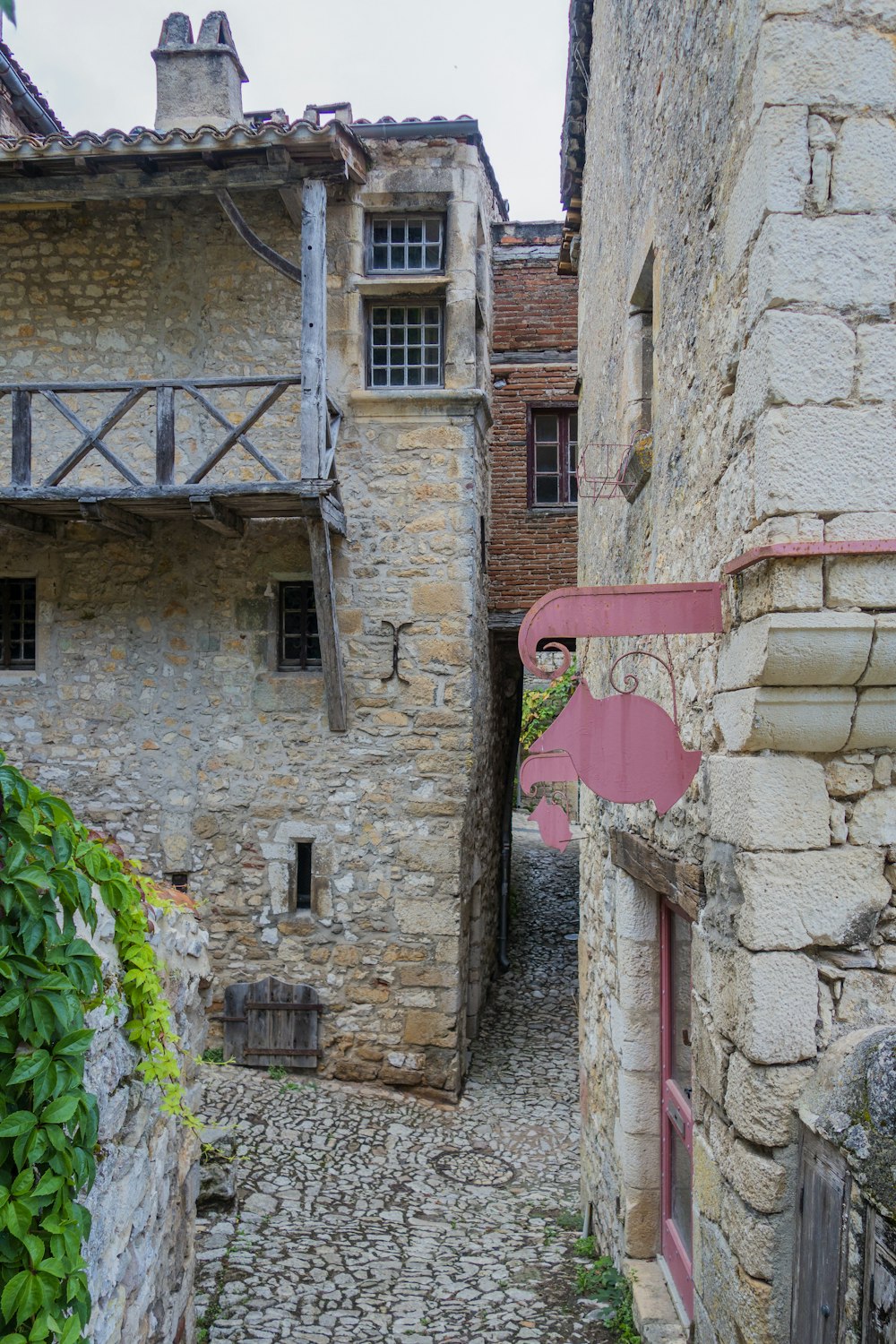 a narrow cobblestone street with stone buildings