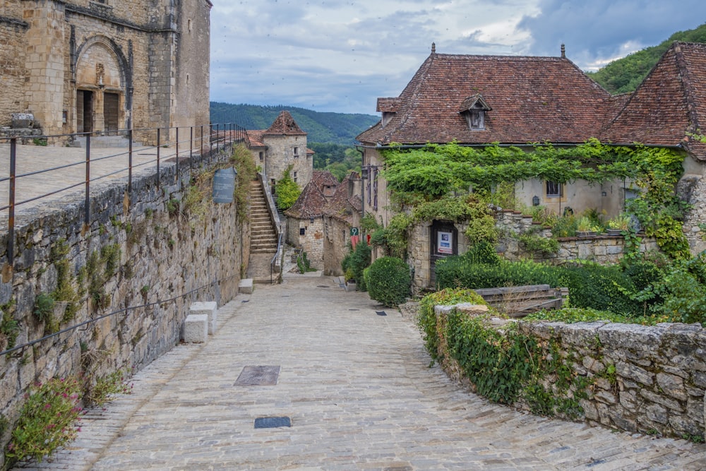 a cobblestone street leading to a castle like building