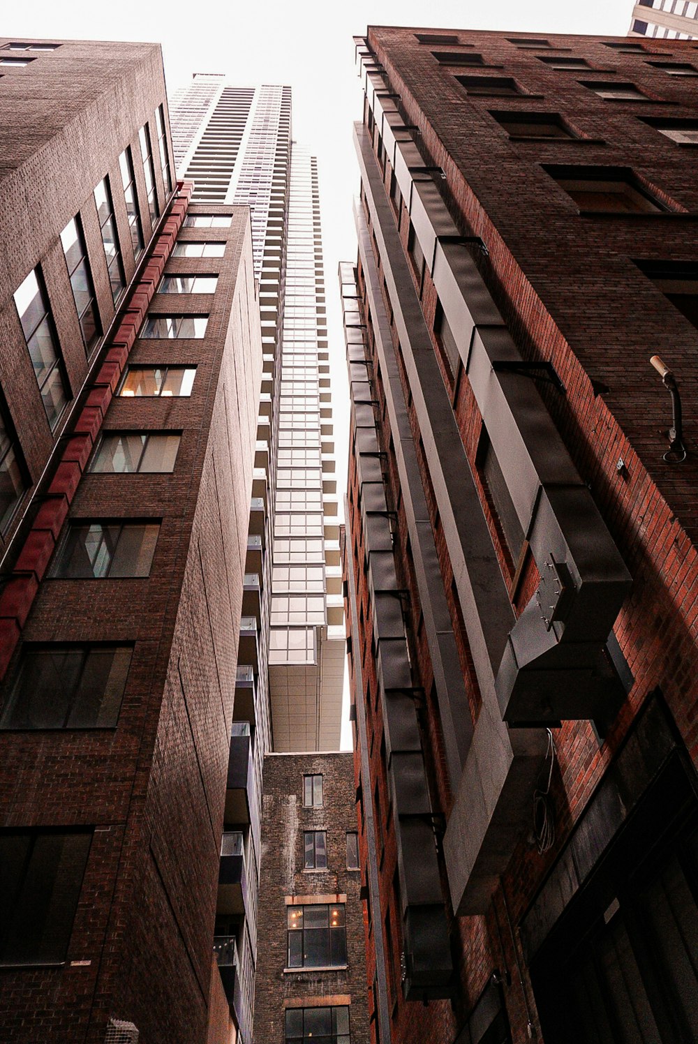 a tall brick building next to other tall buildings