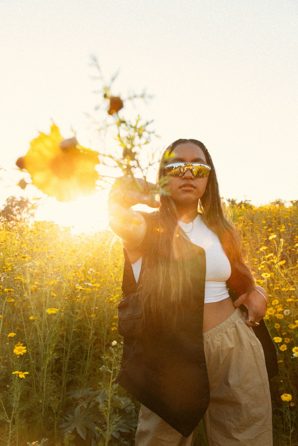 a woman standing in a field of flowers