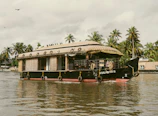 A private balcony on the houseboat with a seating area and panoramic views of the Himalayas.